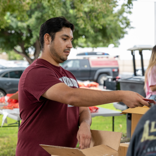 Student volunteering at Pete's Pantry in the Park